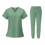 Green medical uniform set with top and pants on a white background