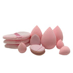 Set of pink makeup sponges on a light pink background