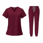 Maroon medical uniform set with top and pants on a white background