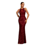 Woman wearing a red sequin evening gown on a white background