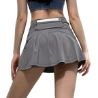 Gray tennis skirt worn by a person on a light gray background