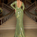 Green sequin dress with long sleeves and open back on a staircase