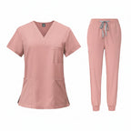 Pink medical uniform set with top and pants on a white background