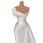 White evening gown on a mannequin against a white background