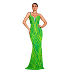 Woman wearing a green evening gown with a geometric pattern against a neutral background