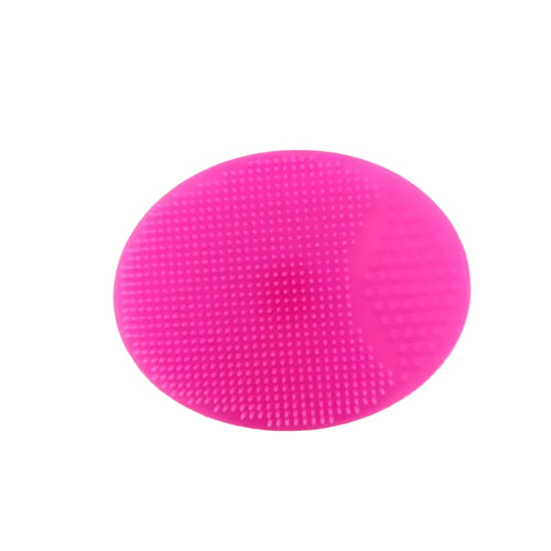 Pink silicone coaster on a white surface with a blurred white mug in the background