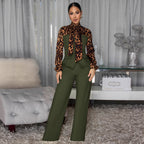 Woman in a green outfit with a leopard print scarf in a living room setting