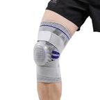 Gray knee brace with blue accents on a person's knee against a light gray background
