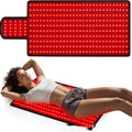 Woman lying on a red LED mat with a close-up of the mat's glowing surface.
