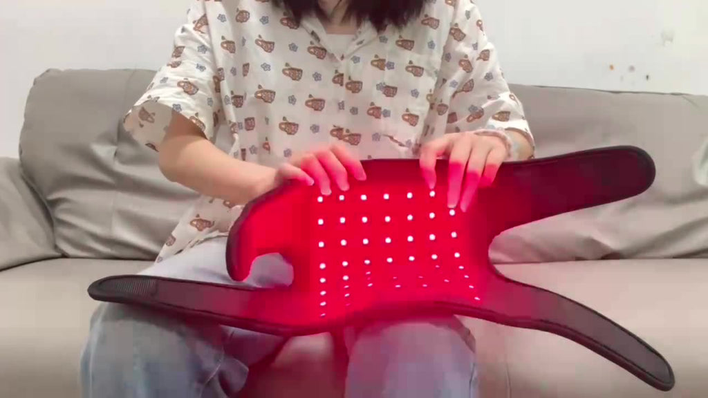Person holding a red guitar pick holder on a couch