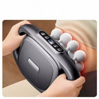 A handheld deep massage device with a dark gray body and white massage heads being used on a person's lower back. The image includes descriptive text at the top about high frequency vibration and 16-wheel massage coverage.